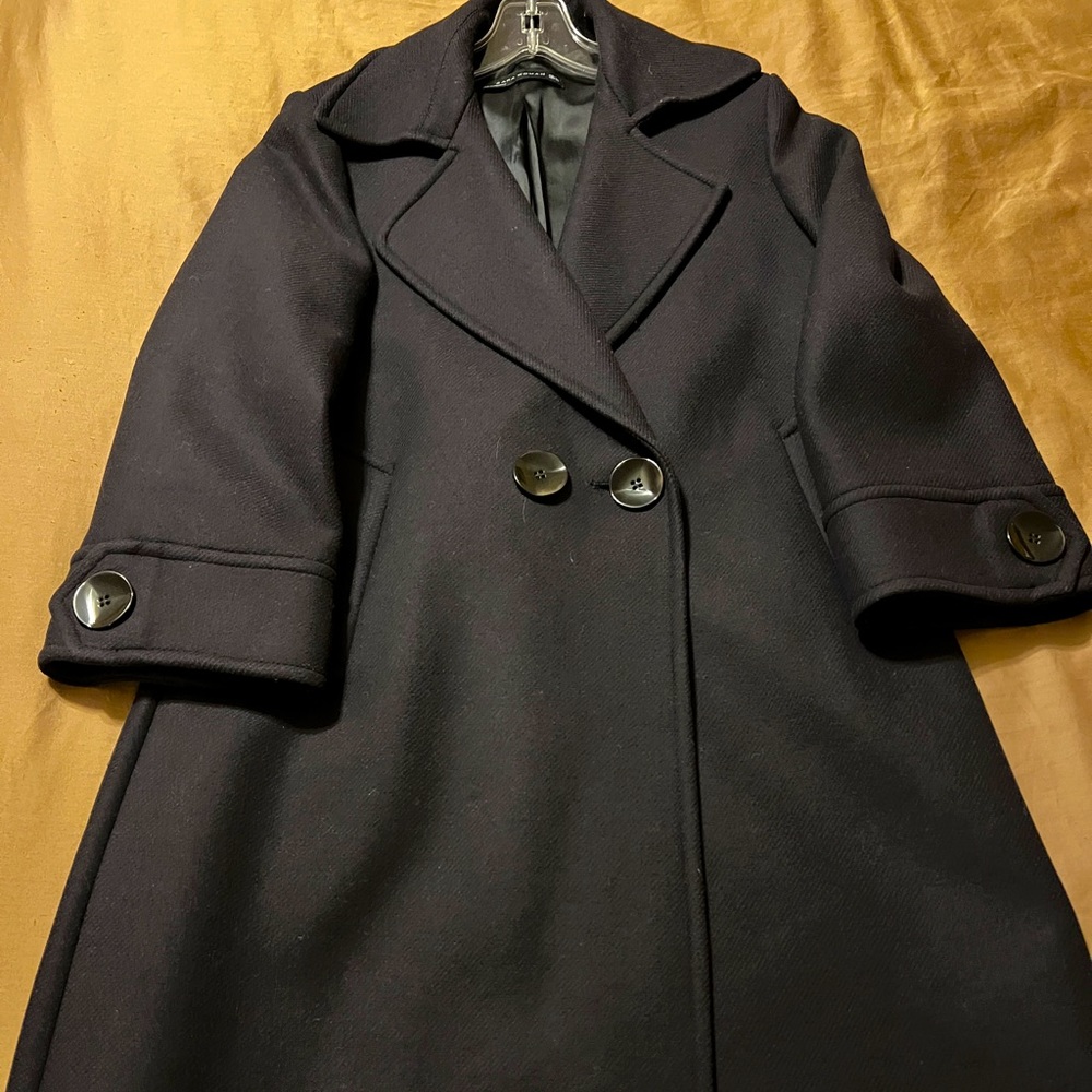 Knee length beautiful navy color and 75% wool